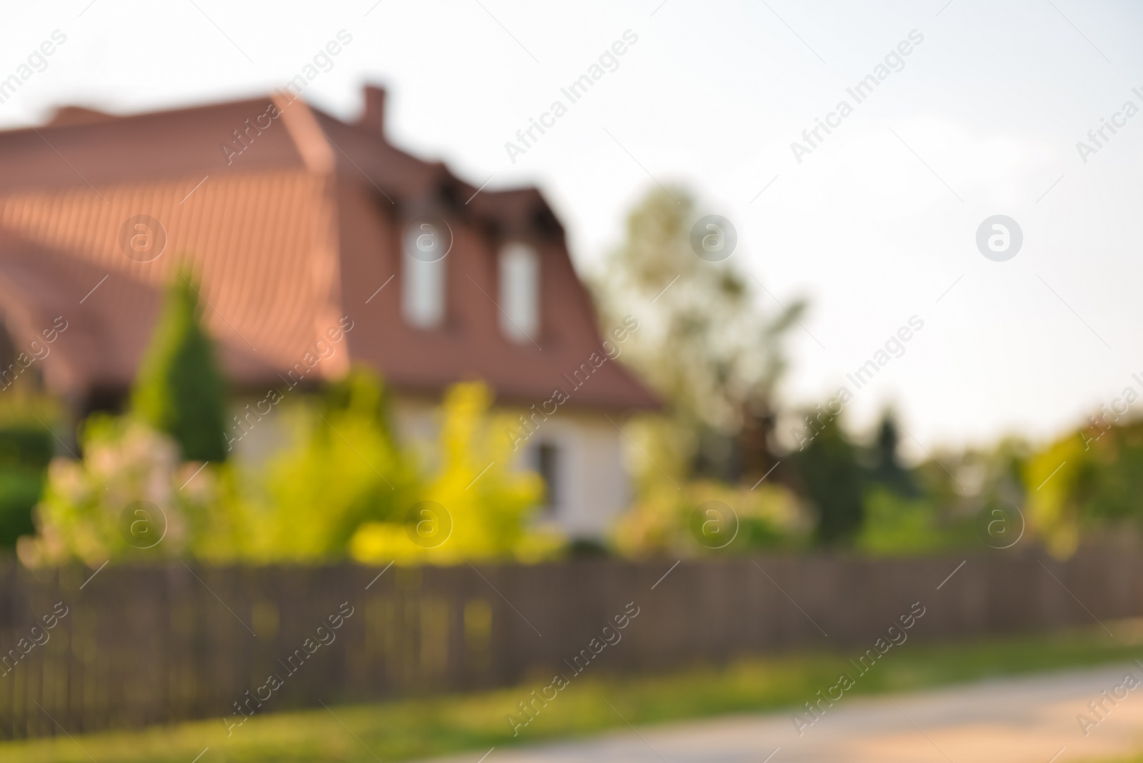 Photo of Blurred view of beautiful house and green shrubberies