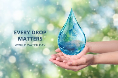 Image of World Water Day. Woman holding icon of drop with Earth image inside on blurred background, closeup