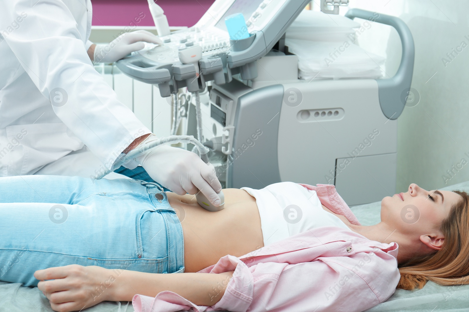 Photo of Doctor conducting ultrasound examination of internal organs in clinic