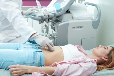 Doctor conducting ultrasound examination of internal organs in clinic