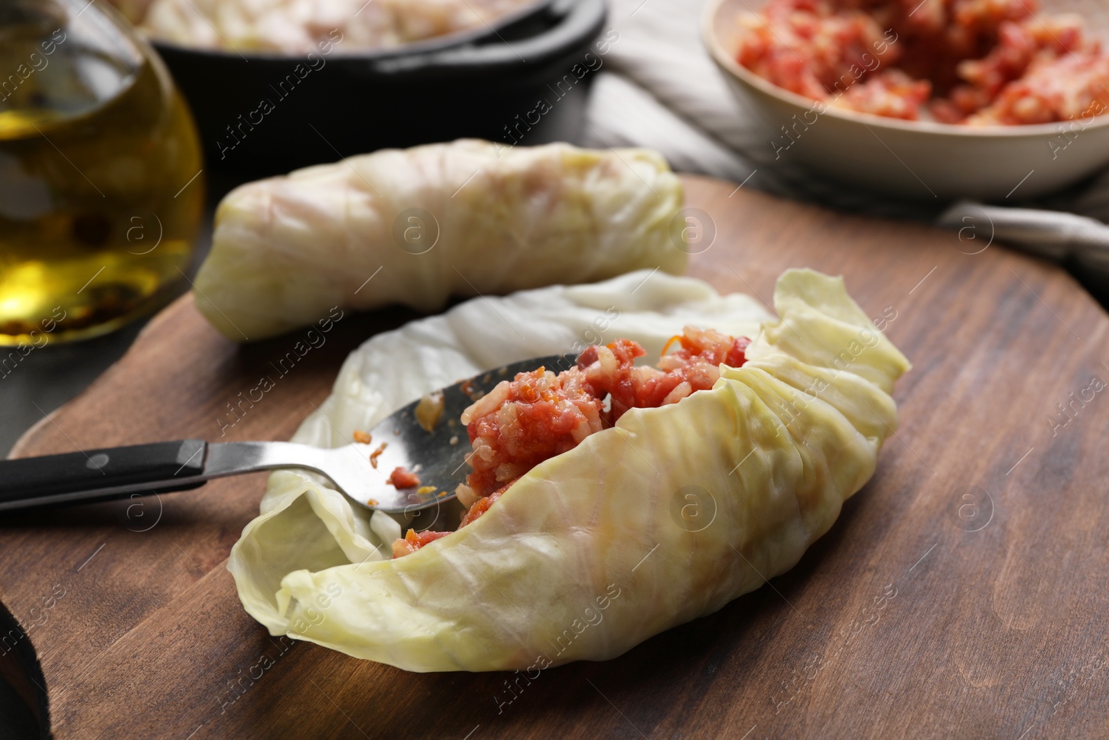 Photo of Preparing stuffed cabbage rolls on table, closeup