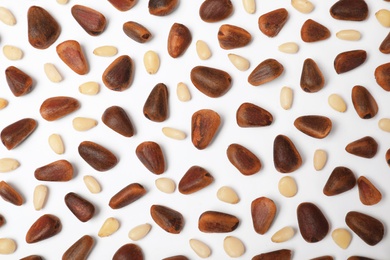 Flat lay composition with pine nuts on white background