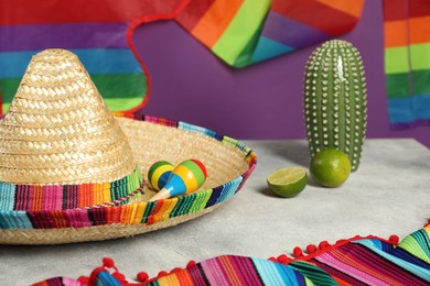 Photo of Composition with Mexican sombrero hat and maracas on grey textured table