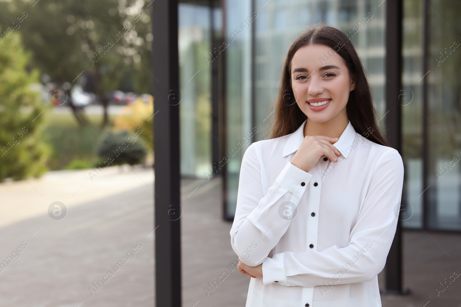 Photo of Portrait of beautiful woman outdoors. Attractive lady smiling and looking into camera. Space for text