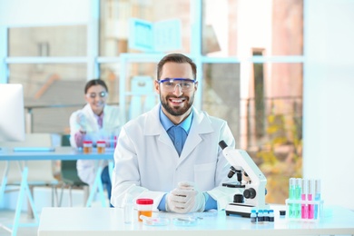 Photo of Young scientist working in laboratory. Chemical analysis