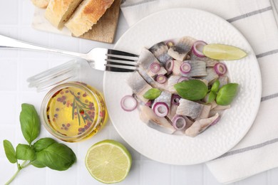 Plate with tasty fish and marinade on light tiled table, flat lay