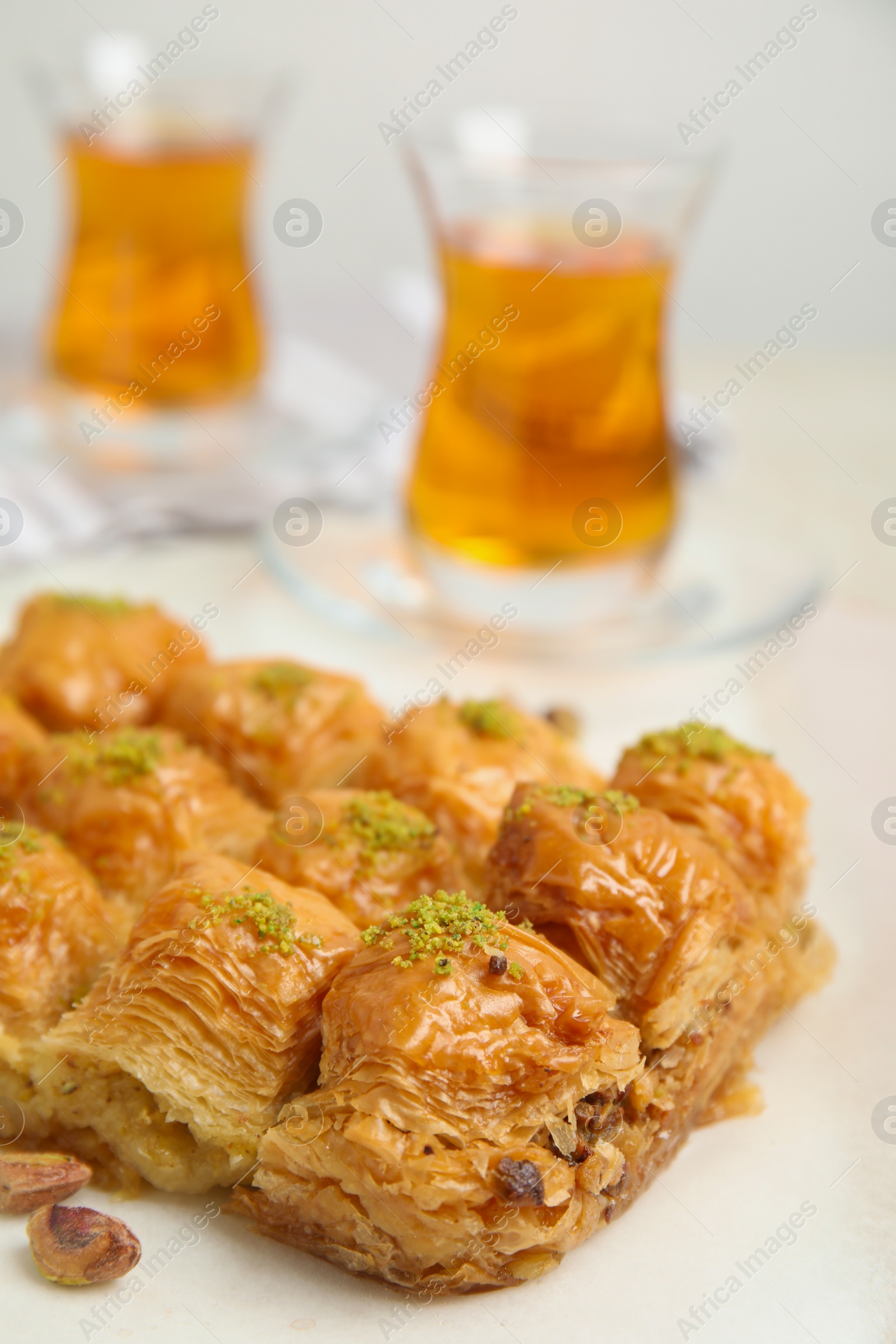 Photo of Delicious sweet baklava with pistachios on table, closeup