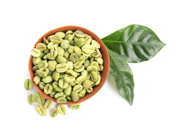 Photo of Wooden bowl with green coffee beans and fresh leaves on white background, top view