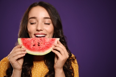 Beautiful young woman with watermelon on purple background. Space for text