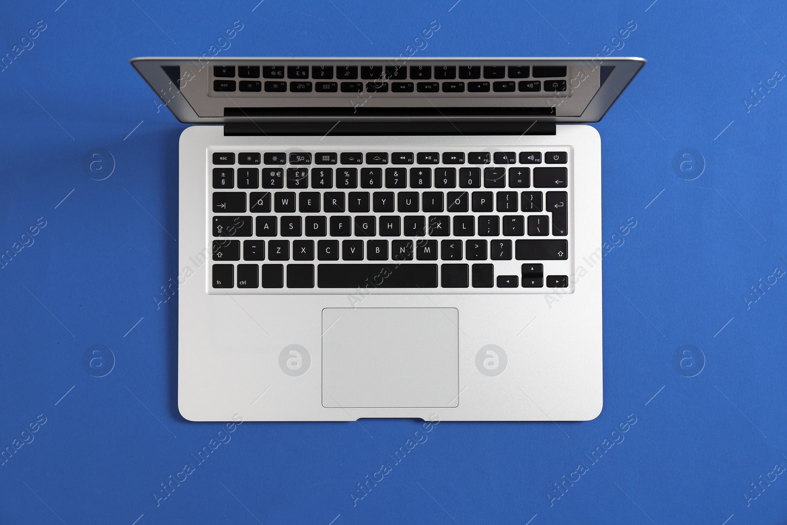 Photo of Modern laptop on color background, top view