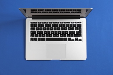 Photo of Modern laptop on color background, top view