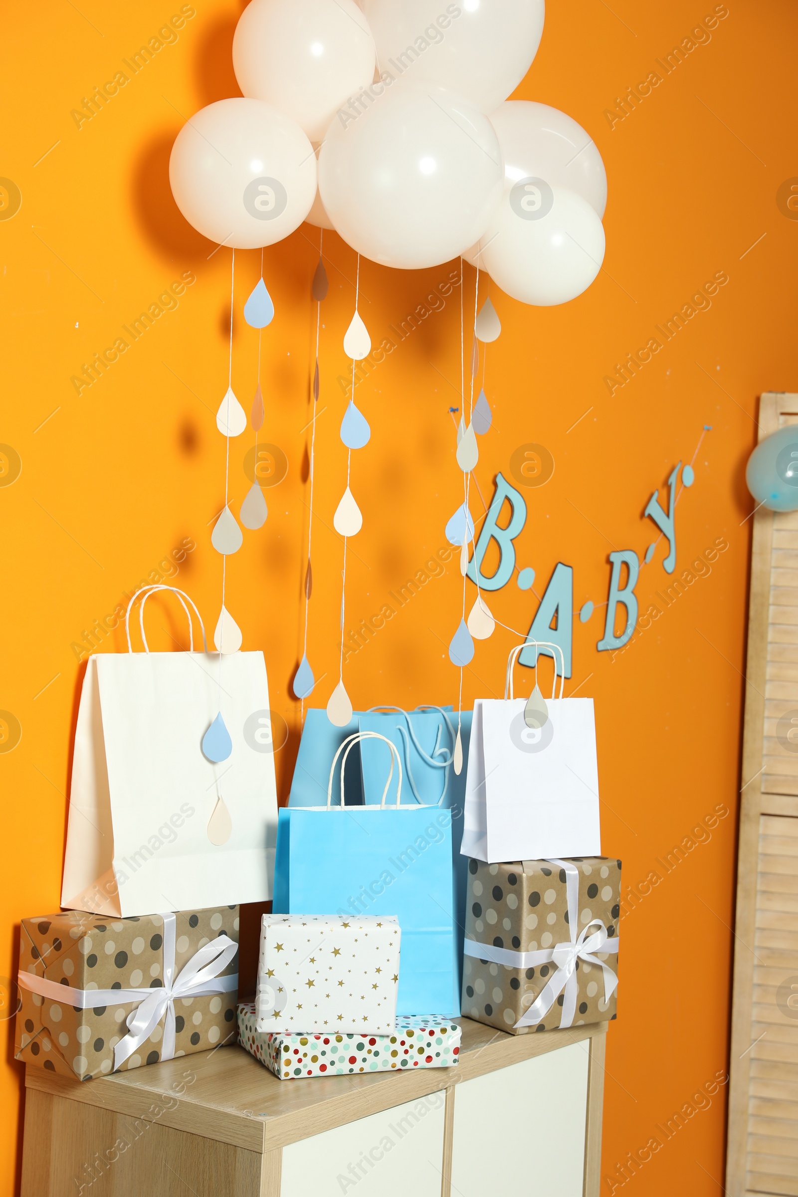 Photo of Baby shower party. Festive decor and gift boxes in stylish room