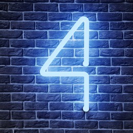 Image of Glowing neon number 4 sign on brick wall