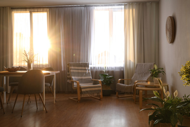 Photo of Windows with stylish curtains in living room interior