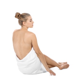 Photo of Young woman with soft towel sitting on white background