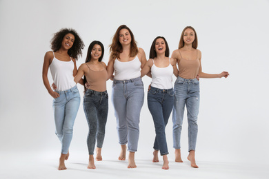 Photo of Group of women with different body types on light background