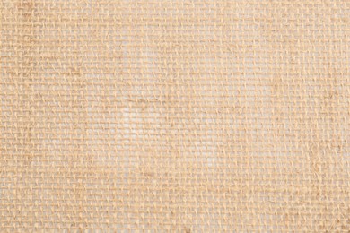 Texture of burlap fabric as background, top view