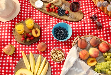 Photo of Delicious food and drinks on picnic blanket, above view