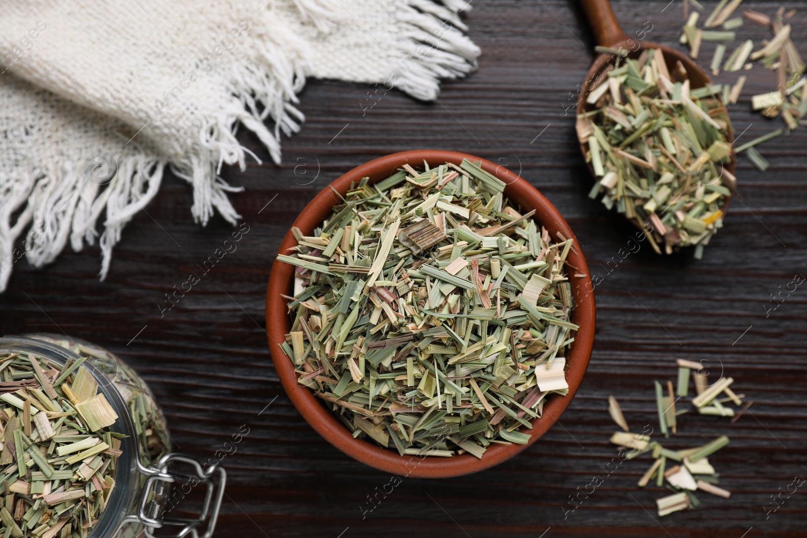 Photo of Aromatic dried lemongrass on wooden table, flat lay