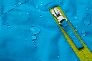 Photo of Light blue waterproof fabric with water drops as background, closeup