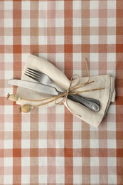 Photo of Stylish setting with cutlery and napkin on table, top view