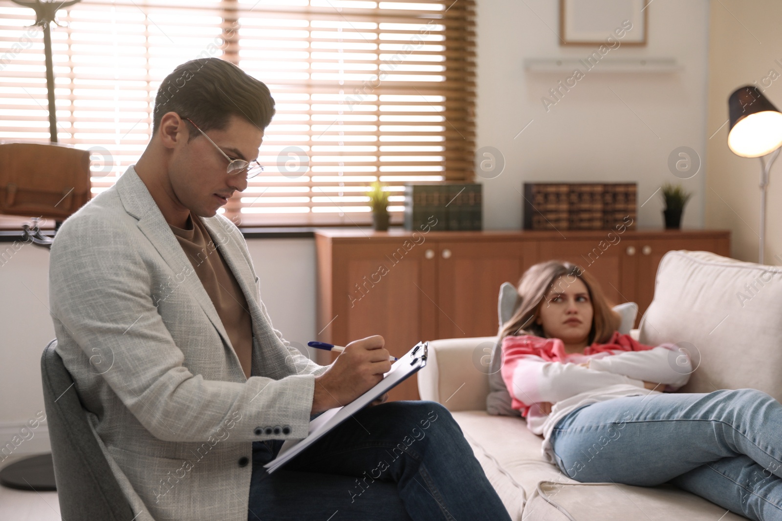 Photo of Professional psychotherapist working with patient in office