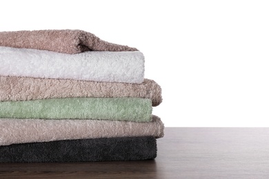 Photo of Stacked soft towels on table against white background
