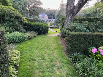 Photo of Netherlands, Amsterdam - July 19, 2022: Luxury hotel Het Roode Koper in beautiful green forest