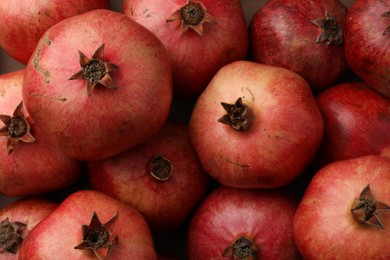 Photo of Fresh ripe pomegranates as background, top view