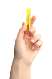 Woman holding yellow plastic clothespin on white background, closeup