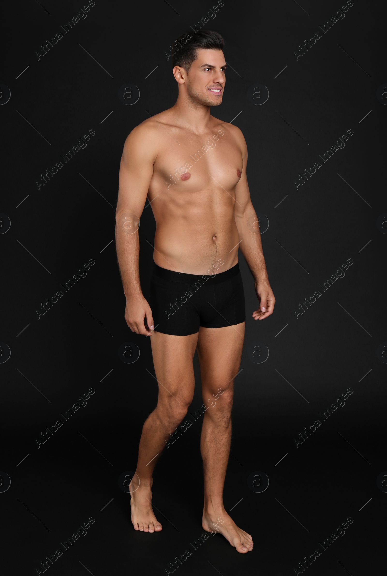 Photo of Handsome man in underwear on black background