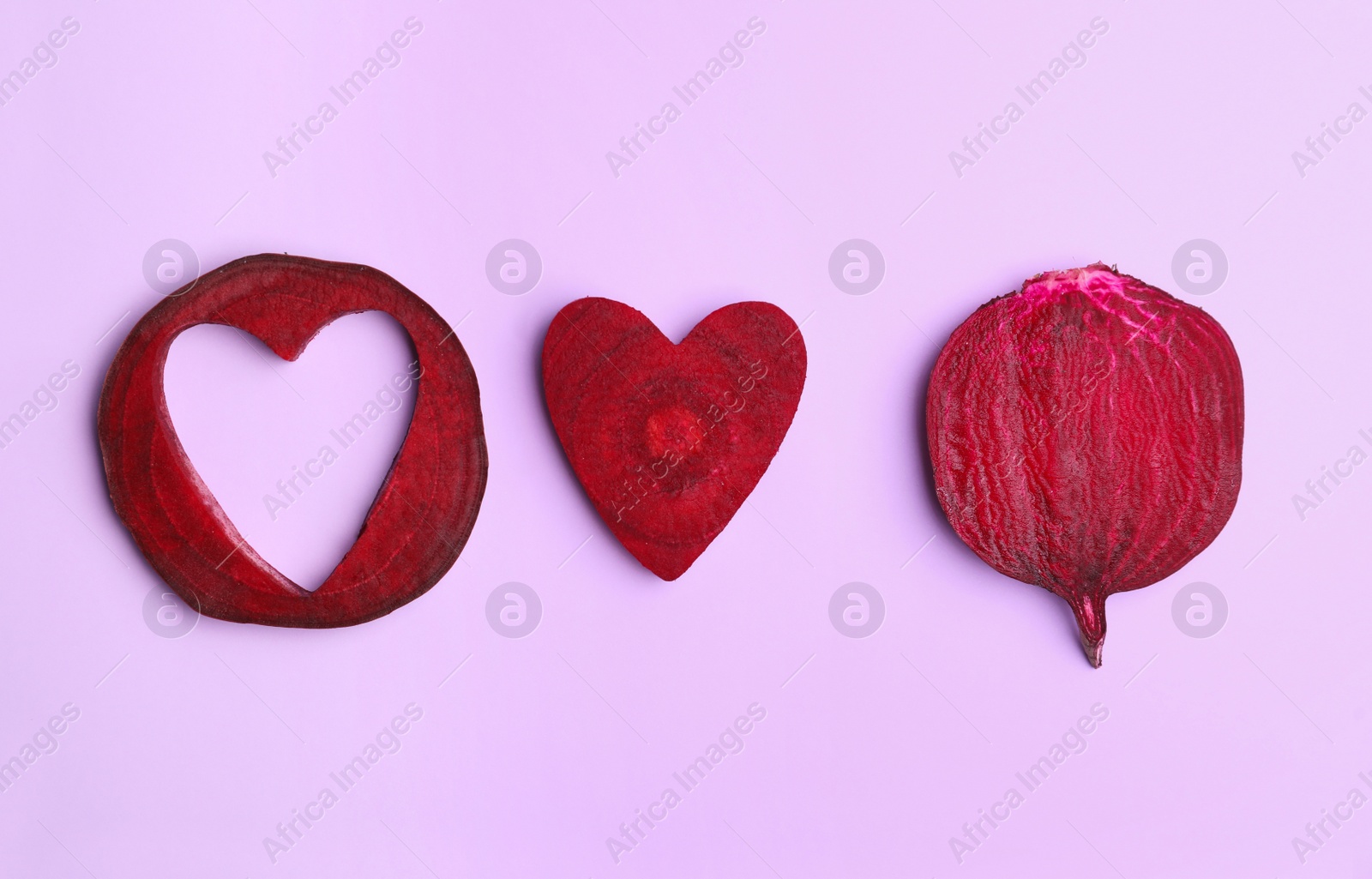 Photo of Flat lay composition with cut raw beets on pink background