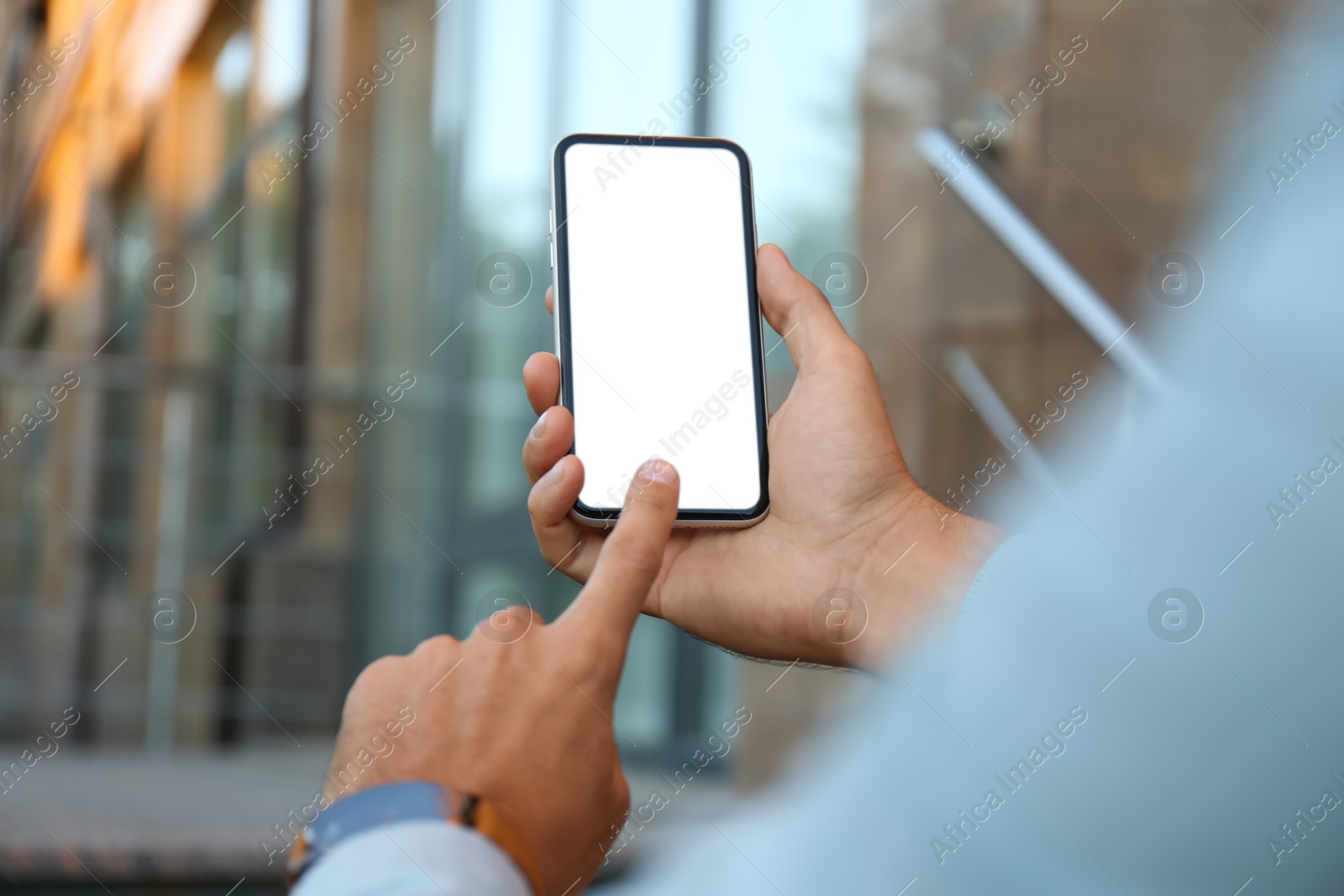 Photo of Man using modern mobile phone outdoors, closeup