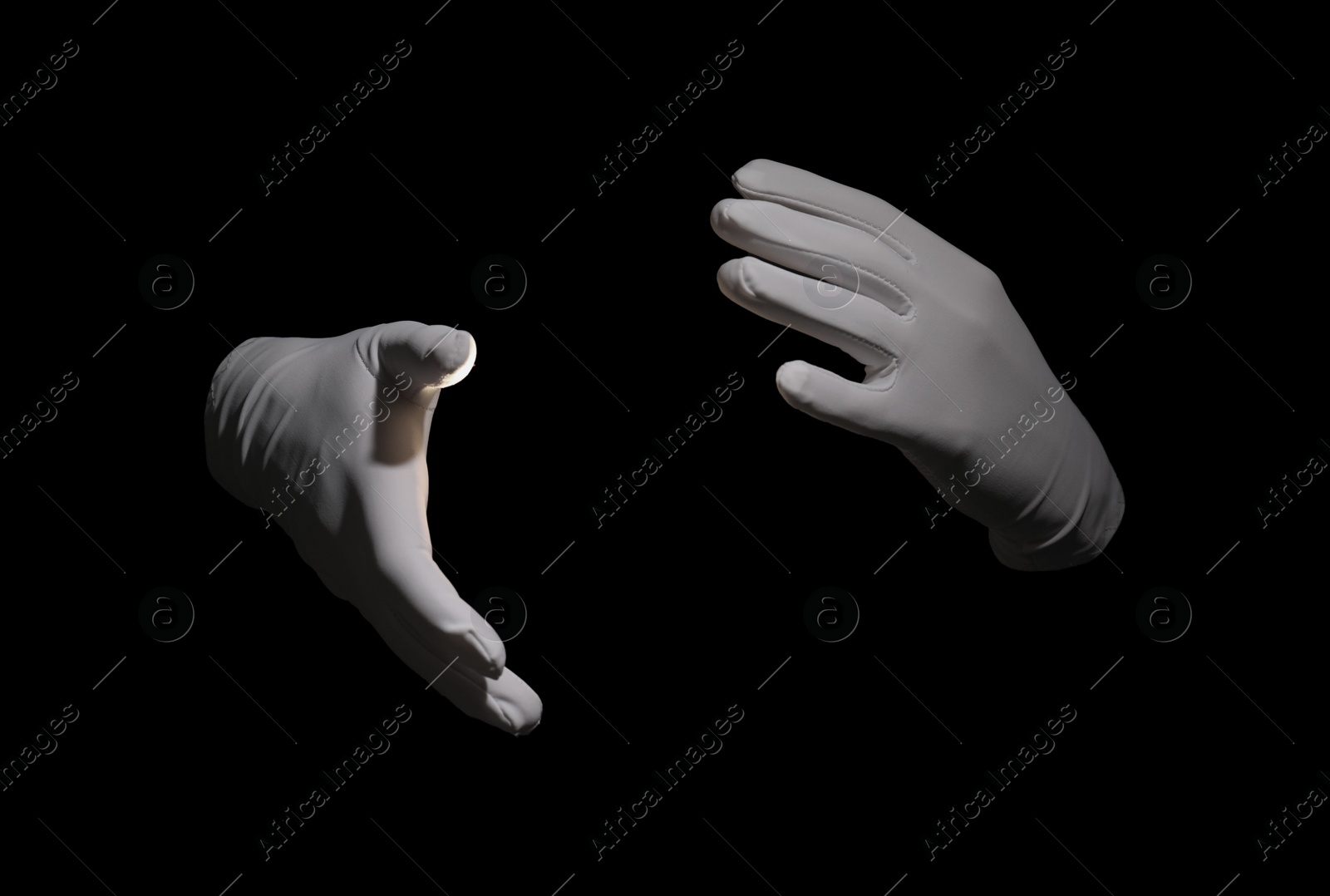 Photo of Magician holding something on black background, closeup