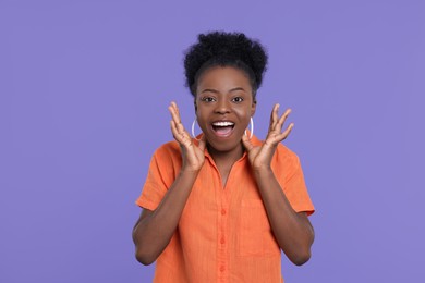 Photo of Portrait of emotional young woman on purple background