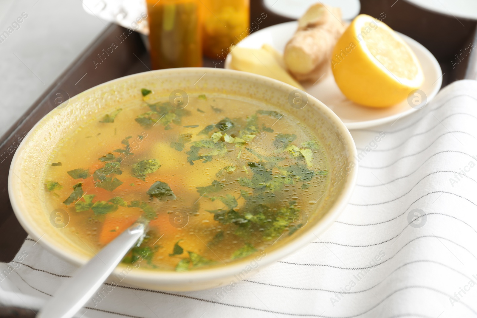 Photo of Bowl with delicious hot broth on table. Cold treatment