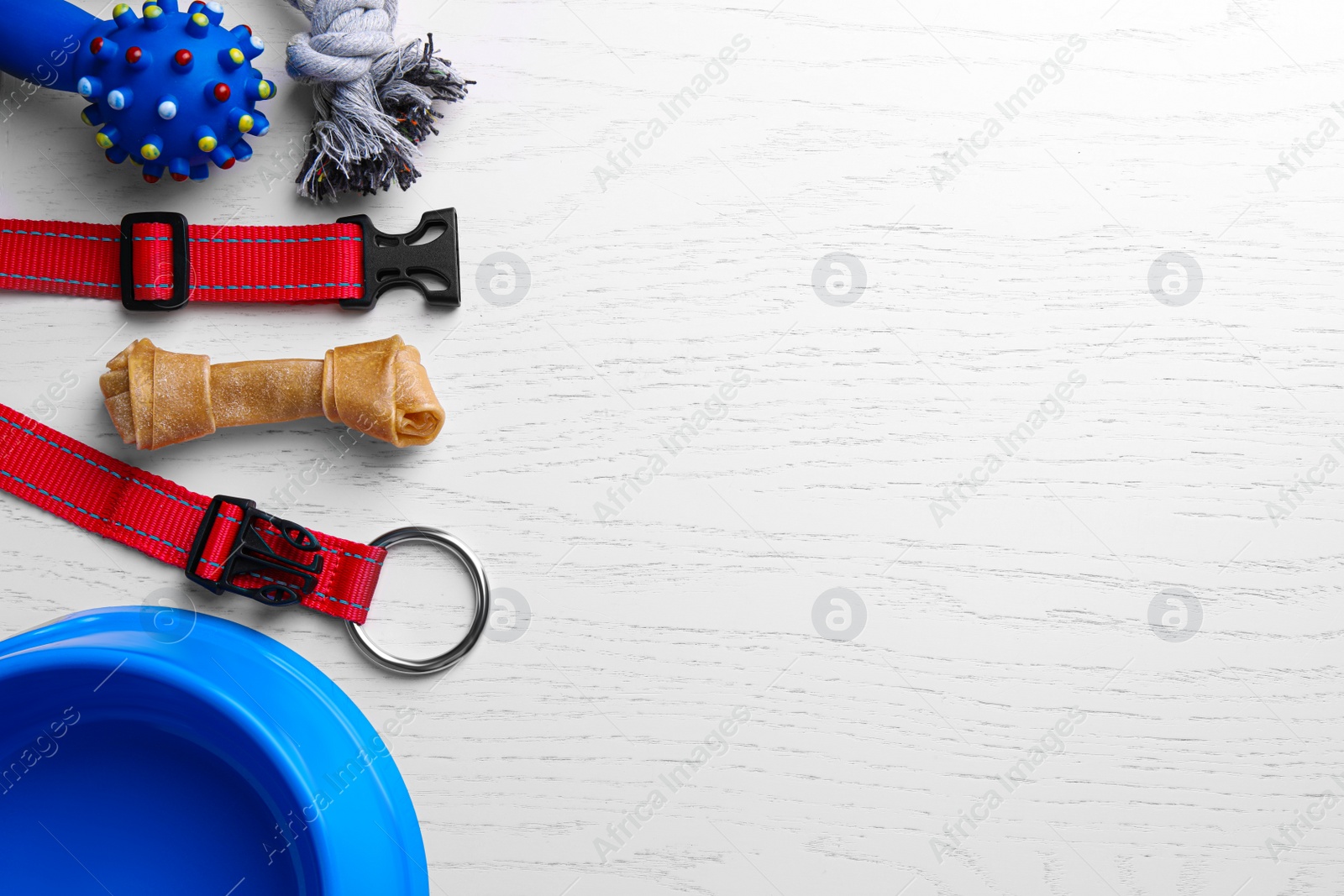 Photo of Flat lay composition with dog collar and different accessories on white wooden table, space for text