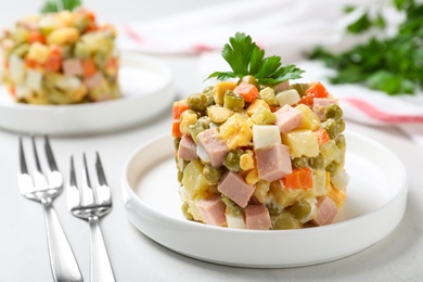 Traditional salad Olivier served on light table