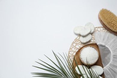 Photo of Flat lay composition with shower cap and spa stones on white background. Space for text