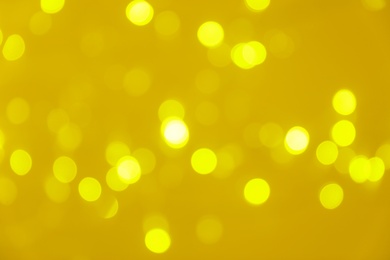 Photo of Blurred view of shiny gold lights. Bokeh effect