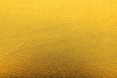 Image of Golden textured surface as background, closeup view