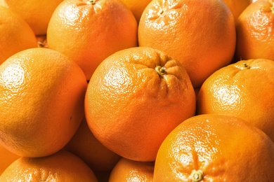 Photo of Many whole fresh ripe grapefruits as background, closeup