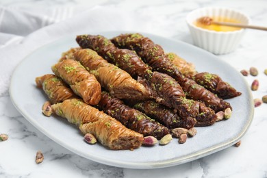 Delicious baklava with pistachio nuts on white marble table