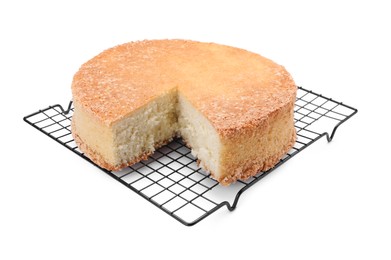 Photo of Baking rack with tasty sponge cake isolated on white