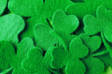 Green clover leaves as background, top view. St. Patrick's Day celebration