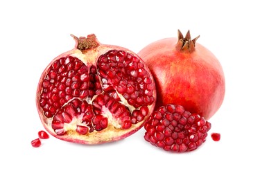 Half and whole pomegranates isolated on white