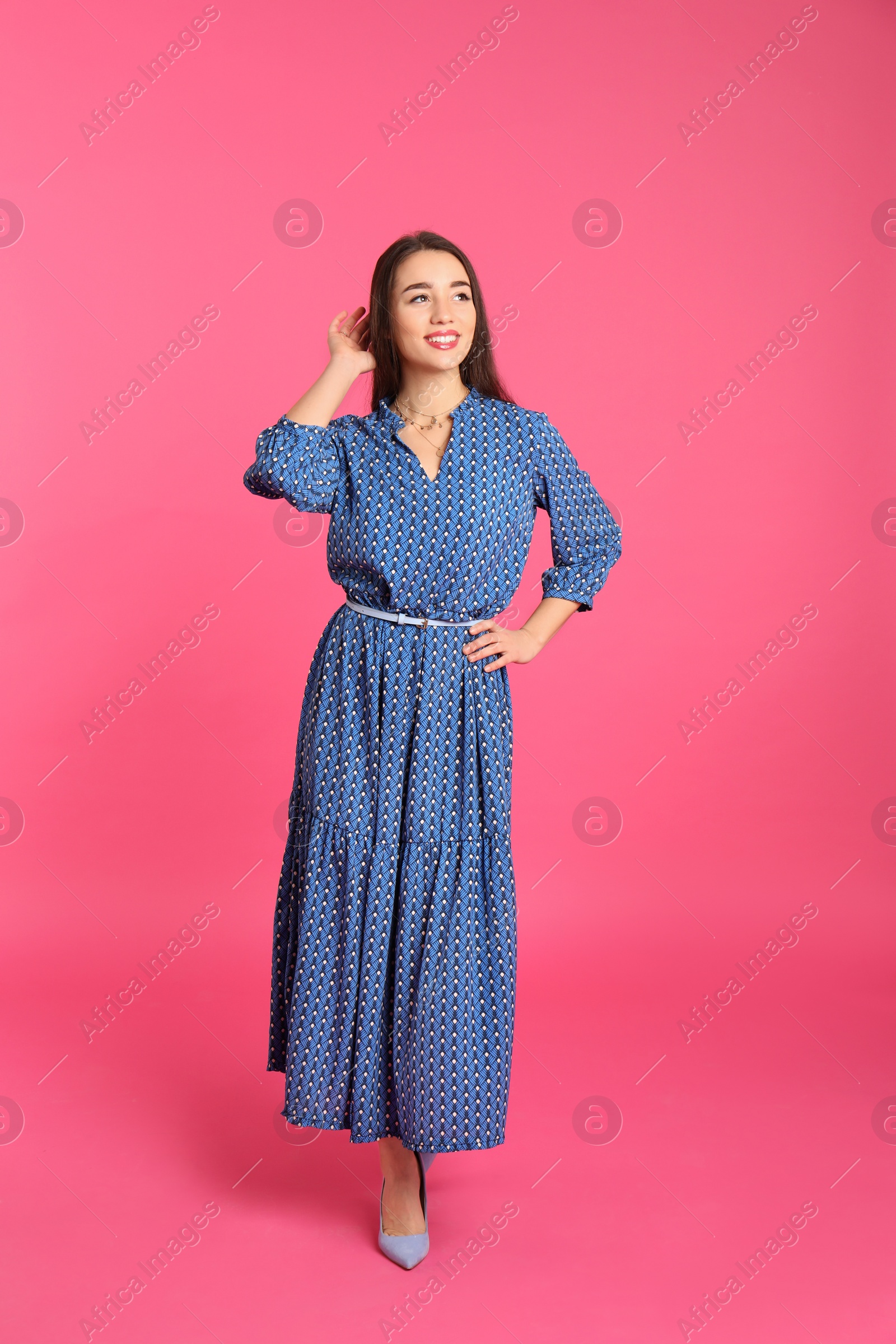 Photo of Portrait of beautiful young woman in stylish dress on color background