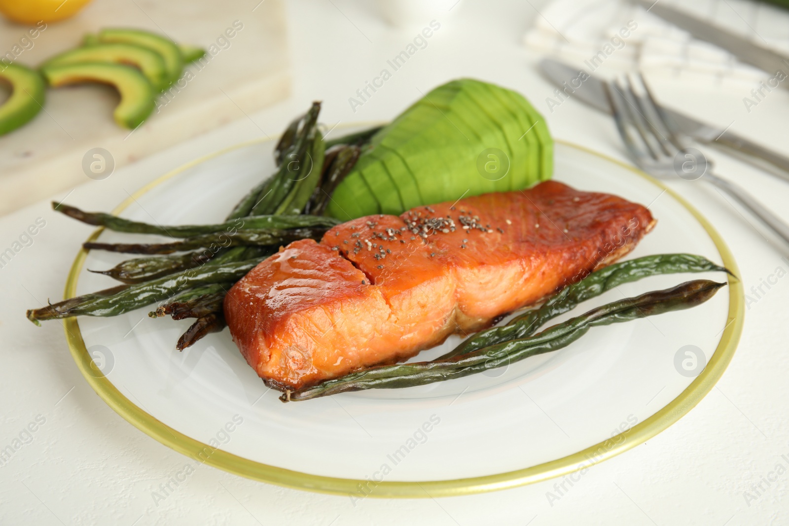 Photo of Tasty cooked salmon and vegetables served on white table. Healthy meals from air fryer