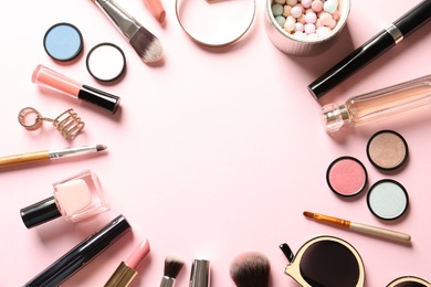 Photo of Flat lay composition with products for decorative makeup on pastel pink background