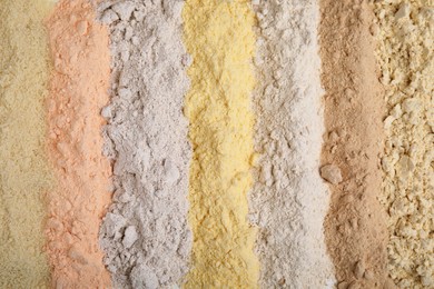 Photo of Different types of flours as background, top view